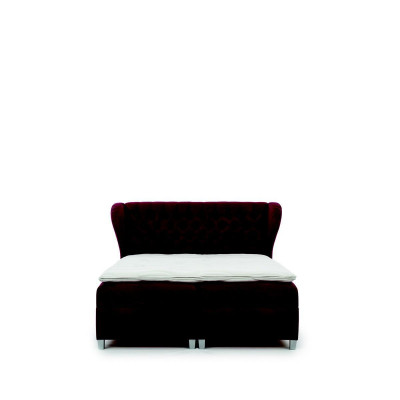 Lussuoso letto boxspring matrimoniale in legno con testiera imbottita dal design moderno.