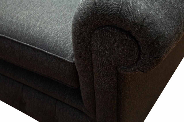 Divano Chesterfield imbottito in tessuto grigio a due posti.