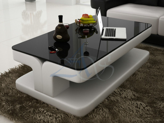 Tavolino design in pelle e vetro per tavoli moderni imbottiti.
