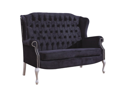 Classico divano Chesterfield a due posti in velluto imbottito.
