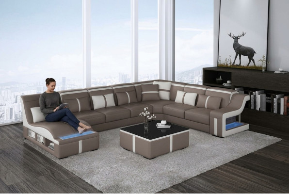 Divano ad angolo imbottito a forma di L in pelle per arredamento.