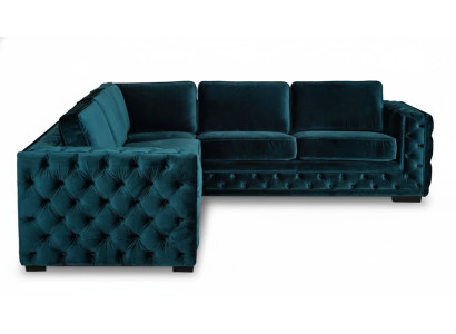 Divano a L a forma di angolo verde Chesterfield di design per arredamento salotto.