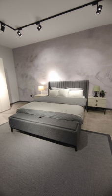 Lussuoso set da camera da letto con letto matrimoniale di design elegante e 2 comodini.
