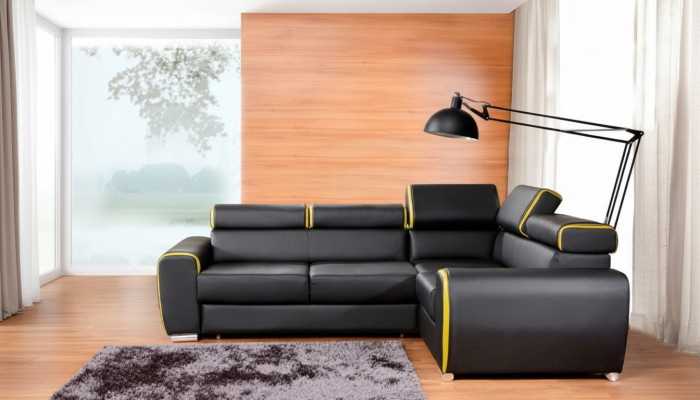 Divano ad angolo design a L con funzione letto in pelle e tessuto.