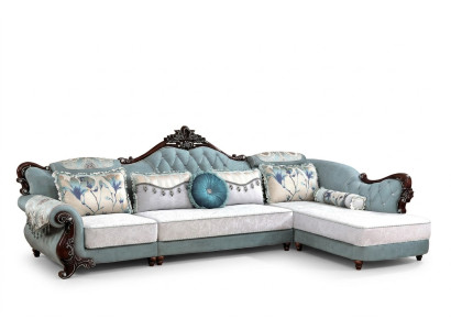 Divano classico in tessuto Chesterfield angolare con pouf e cuscini.