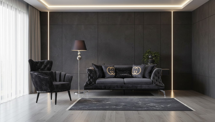 Divano nero Chesterfield a tre posti più uno per il salotto.