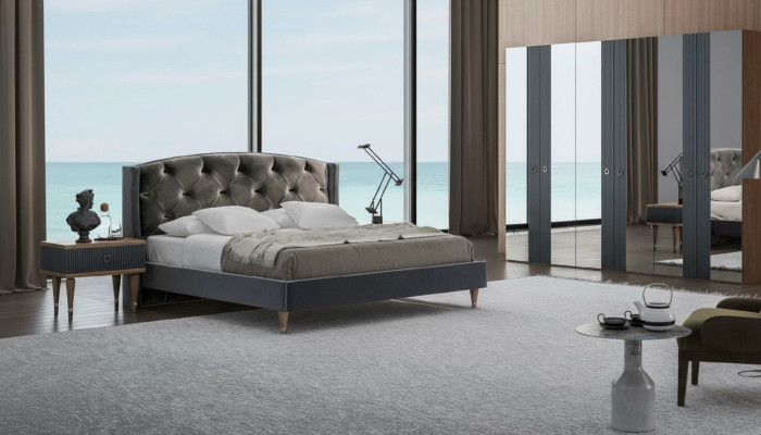 Set da camera da letto Chesterfield moderno con letto matrimoniale design e comodini.