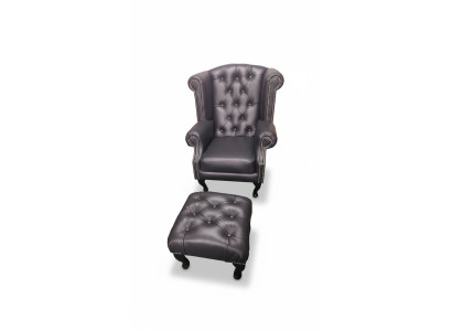 Lussuosa poltrona con poggia piedi Chesterfield in pelle nera moderna.