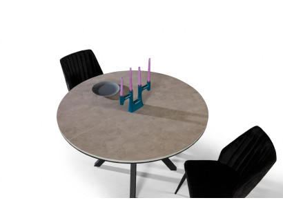 Tavolo da pranzo rotondo allungabile in legno grigio.
