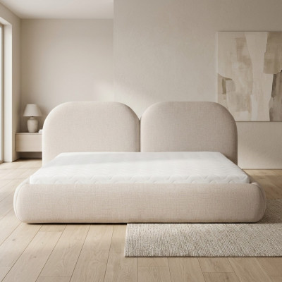 Camera da letto beige con letto matrimoniale, testiera rotonda in tessuto, letti imbottiti nuovi.