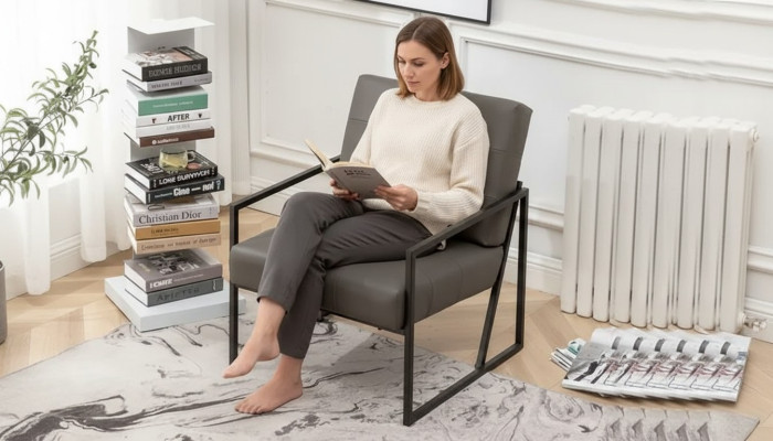 Salotto Poltrona Grigia Scuro con gambe in metallo e rivestimento in tessuto.